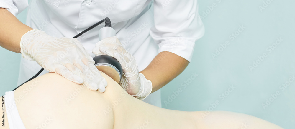 Cavitation rf body treatment. Female ultra sound lipo machine. Spa contouring. Doctor hands