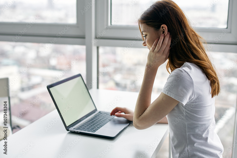 young woman working on her laptop at home young woman working on her laptop at home