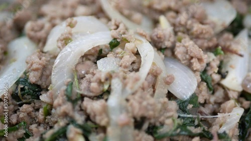Closeup of spicy stir-fried minced pork with holy basil (Pad Kra Pao) - one of the most common street foods in Thailand