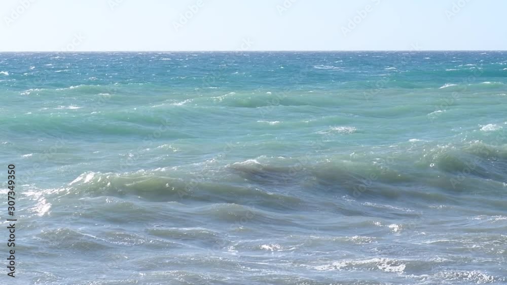 Winter sea in Puglia. Waves run to the shore, the wind blows. The concept of change, inconstancy or anger, annoyance Winter sea in Puglia. Waves run to the shore, the wind blows. The concept of change, inconstancy or anger, annoyance