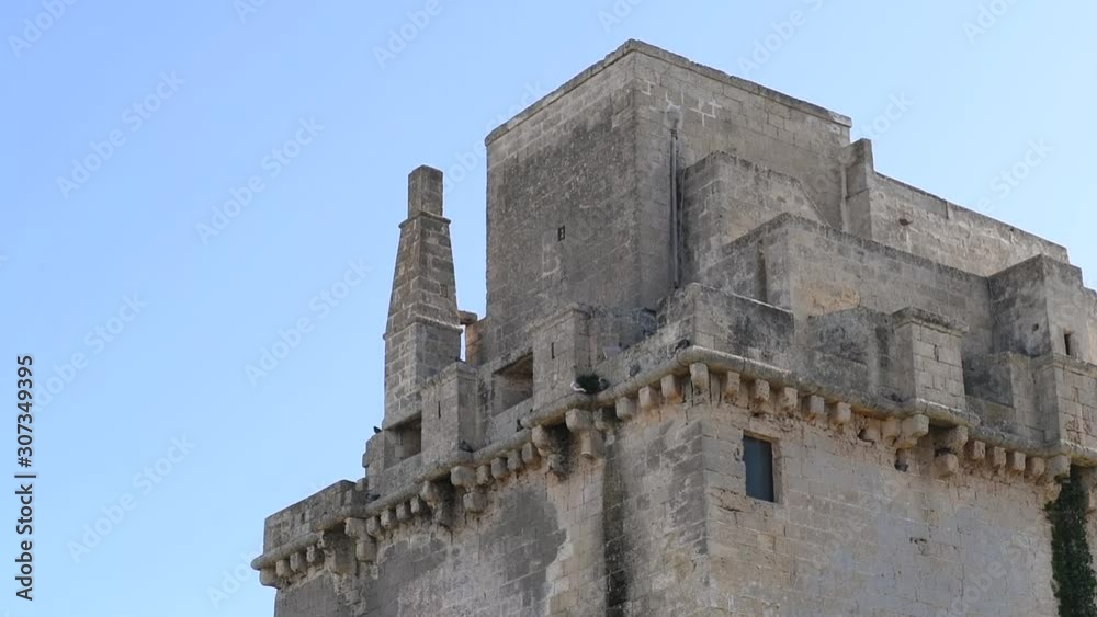Close up on the ancient fortified tower in a seaside landscape of a touristic resort in Puglia , Italy. Historical monument of Torre Colimena's port. Close up on the ancient fortified tower in a seaside landscape of a touristic resort in Puglia , Italy. Historical monument of Torre Colimena's port.