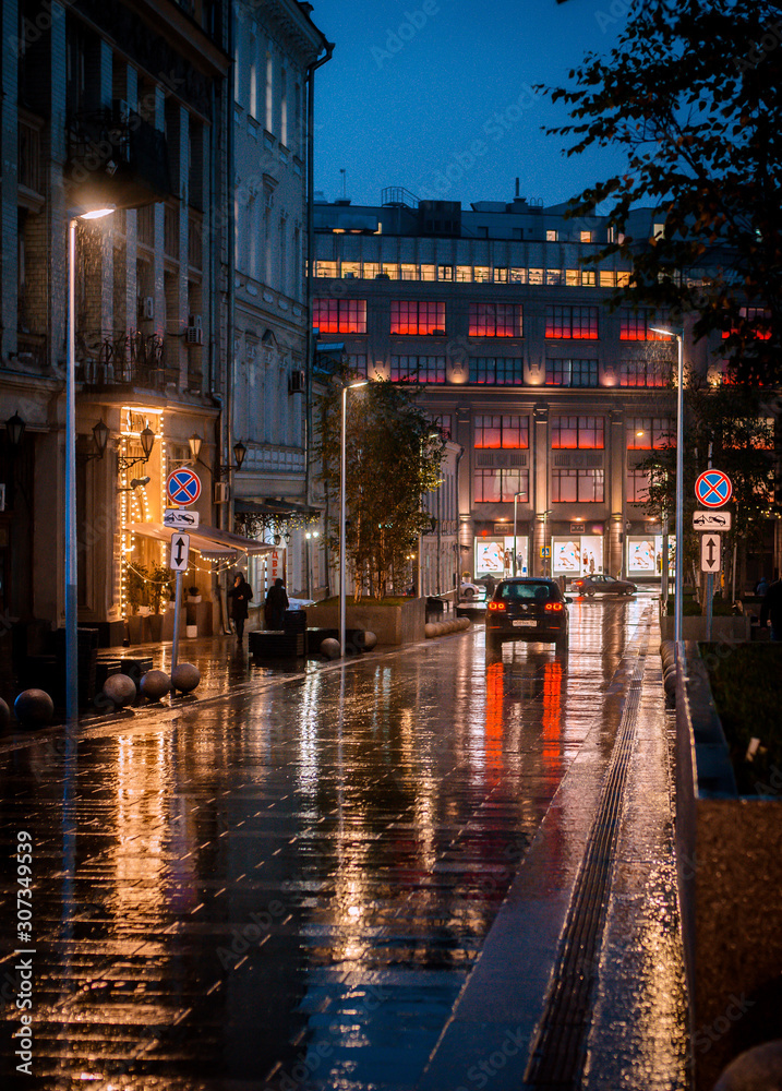 Wet night city street rain Bokeh reflection bright colorful lights puddles sidewalk Car