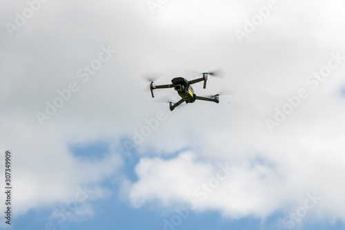 close up of drone for photography in the blue sky and white clouds.  