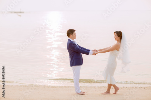 Young asian groom and bride posing and smiling for pre-wedding shot
