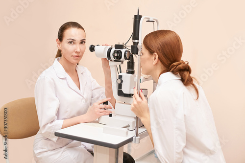 Eye ophthalmologist exam. Eyesight recovery. Astigmatism check concept. Ophthalmology diagmostic device. Beauty girl portrait in clinic