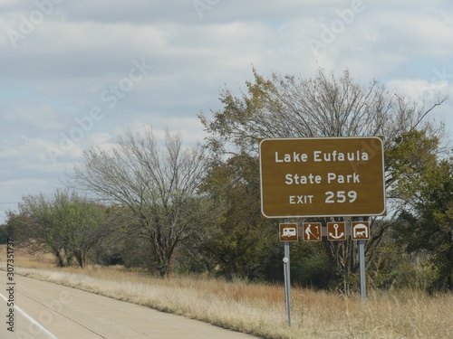 Wide shot of a roadside sign to Lake Eufaula State park, Oklahoma. photo