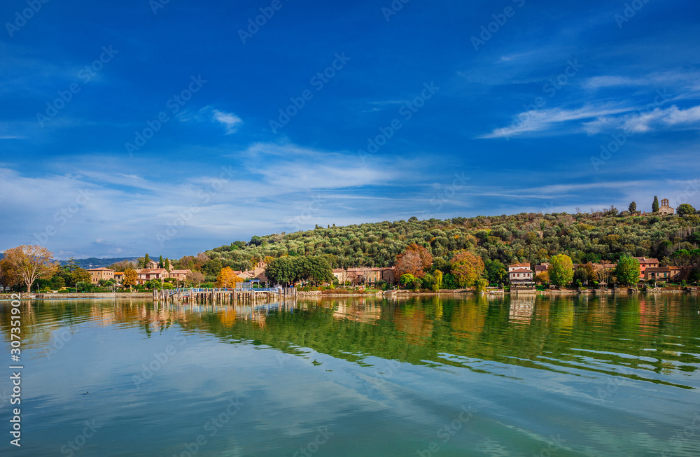 Isola Maggiore (Greater Island) of Lake Trasimeno in Umbria, with small village waterfront and the medieval St Micheal Archangel church at the top