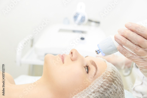 Dermatology skin care facial therapy. Medical spa anto wrinkles procedure. Woman face rejuvenation. Pretty girl. Rf cosmetician equipment