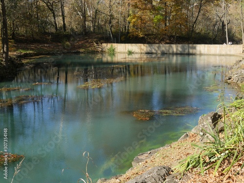 Blue spring view, with the colorful trees reflected in the waters in autumn photo