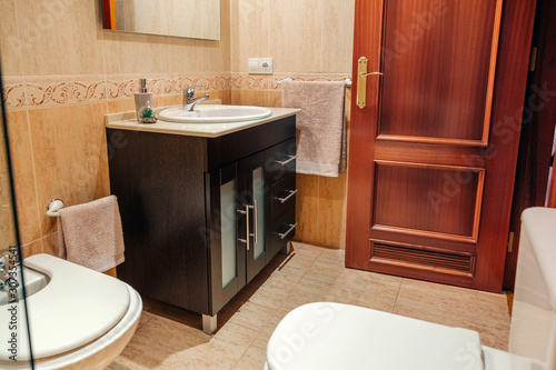 Slika na platnu Interior of tidy bathroom with washbasin cabinet