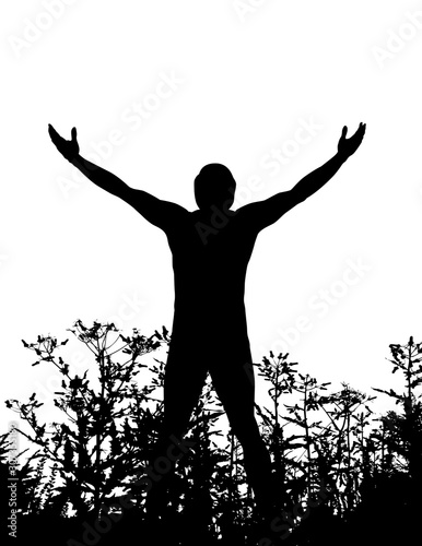 A man standing in nature with arms upward in gratitude to the universe