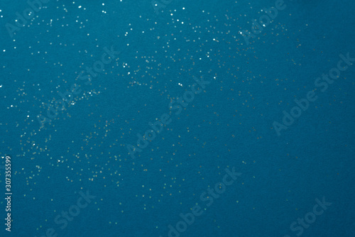 Rich blue paper background with sequins. Copy space for text © Sunshine