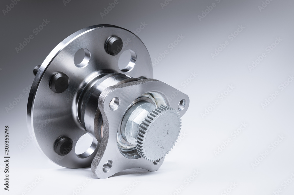 New Wheel hub assembly with bearing. This is part of the car suspension on a gray background with a gradient. The concept of new car parts New Wheel hub assembly with bearing. This is part of the car suspension on a gray background with a gradient. The concept of new car parts