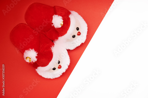 pair of fluffy Santa slippers on white background