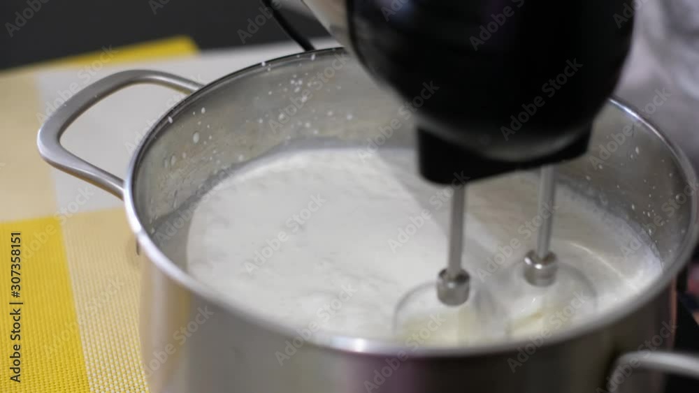 Cooking Whipping Cream In a Mixer. Whipped Cream. Closeup. Cream Whisk