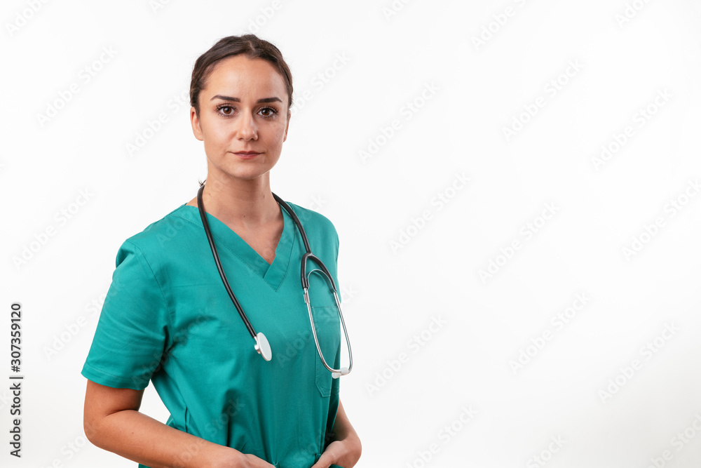 Cheerful female doctor in green uniform. Portrait of nurse in with stethoscope. Cheerful female doctor in green uniform. Portrait of nurse in with stethoscope.