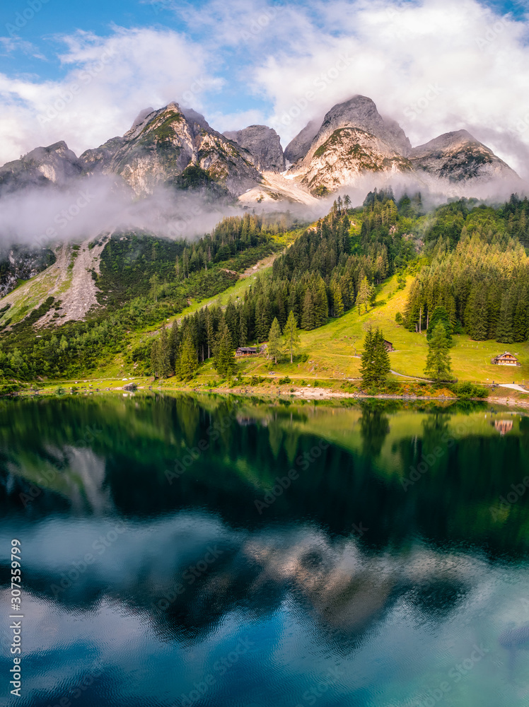 Beatiful view over the Gosau see in Austria towards Donnerkogel mountain, during fall with cloudy weather over the mountains Beatiful view over the Gosau see in Austria towards Donnerkogel mountain, during fall with cloudy weather over the mountains