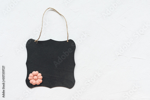 Black board and flower cookie on a white background