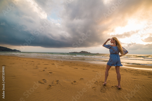 Blonde model on the beach at sunset