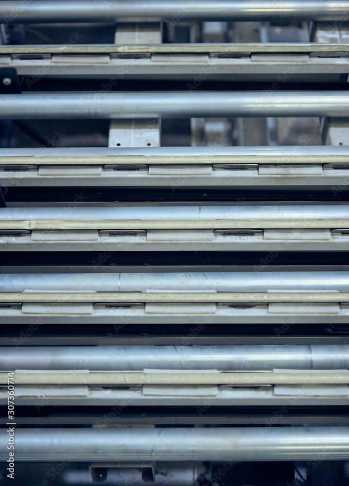 An empty industrial roller conveyor belt in a fully automated factory. roller conveyor to easily move heavy industrial goods around without the need for humans.future of industrial manufacture.