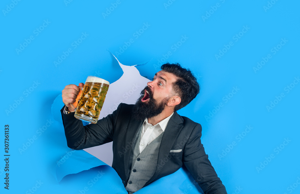 Lager and dark beer. Bearded man holds craft beer looking through paper hole. Drinks, alcohol, leisure, people concept. Stylish man with beard hold mug of beer. Bearded man drinking beer. Oktoberfest. Lager and dark beer. Bearded man holds craft beer looking through paper hole. Drinks, alcohol, leisure, people concept. Stylish man with beard hold mug of beer. Bearded man drinking beer. Oktoberfest.