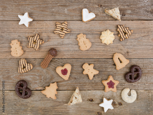 many different nice christmas cookies on wooden background photo taken from above