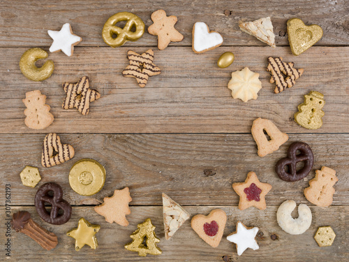 many different nice christmas cookies on wooden background photo taken from above