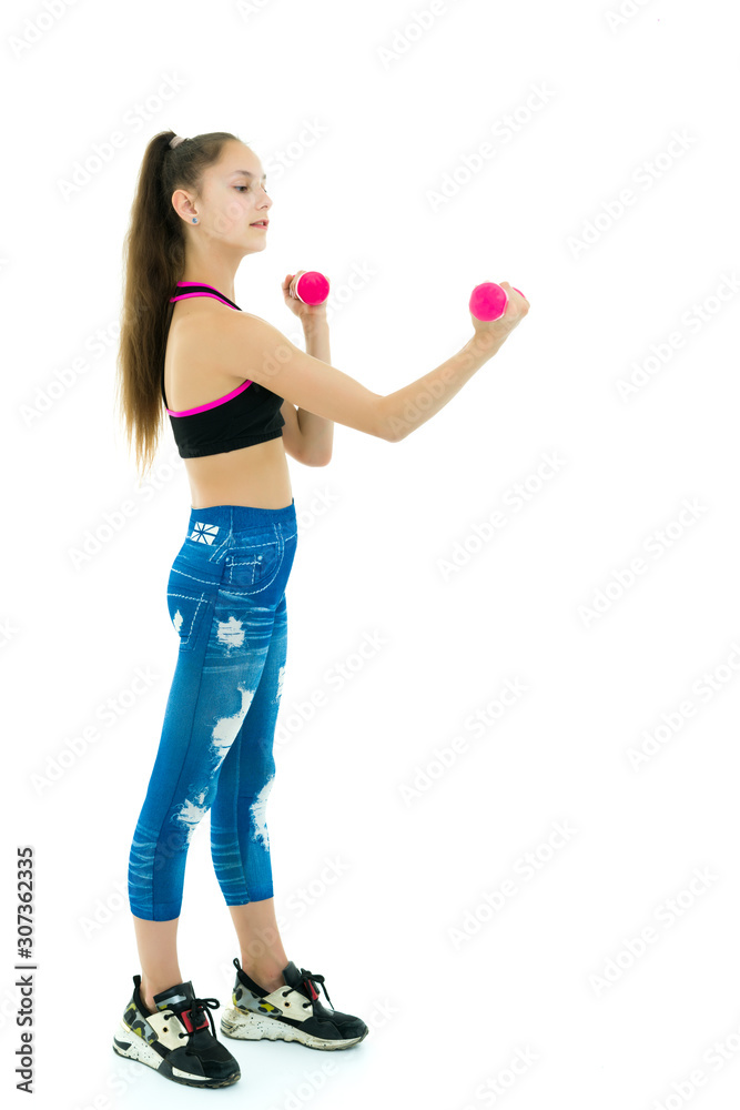 Teenage girl with dumbbells in hands
