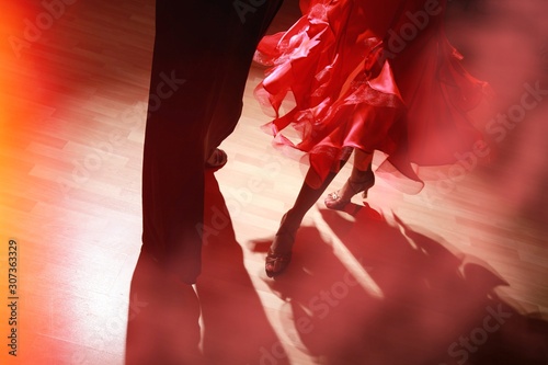 Fototapeta Man and woman dancing Salsa on dark