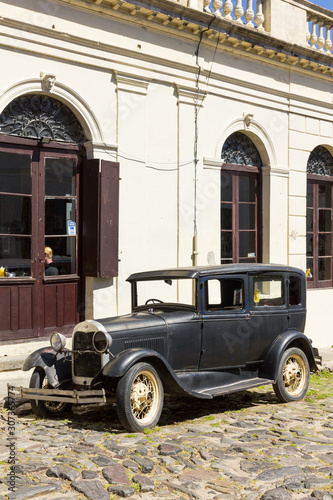 Black and obsolete car on one of the cobblestone streets, in the city of Colonia del Sacramento, Uruguay. It is one of the oldest cities in Uruguay. © Toniflap