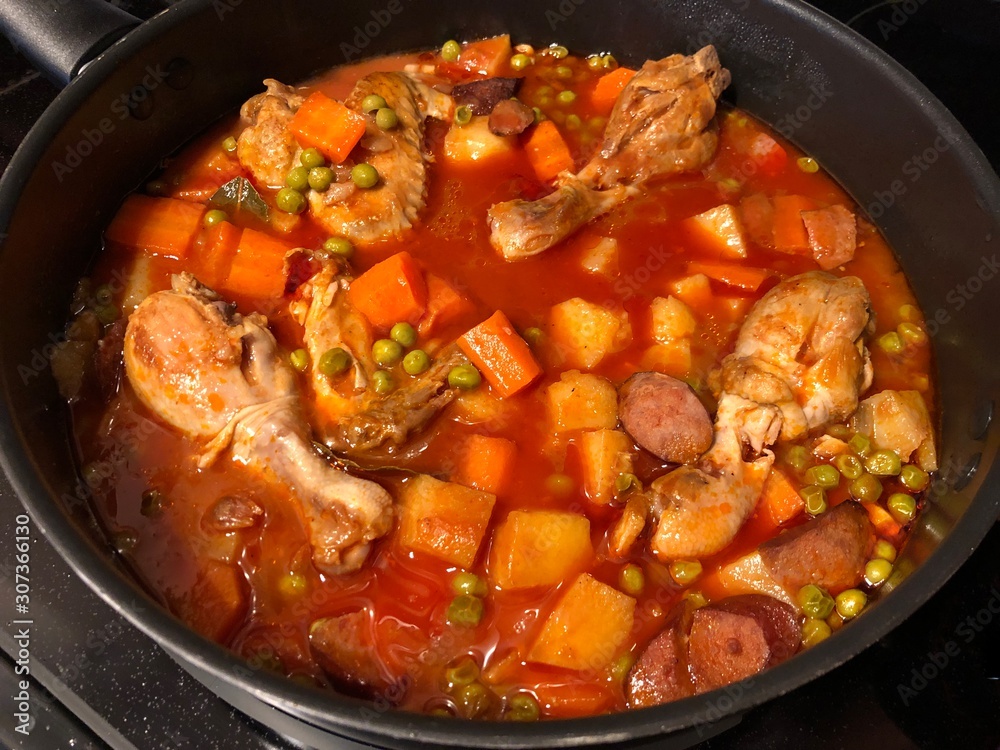 Medium wide shot of a chicken menudo dish, popular in the Philippines.