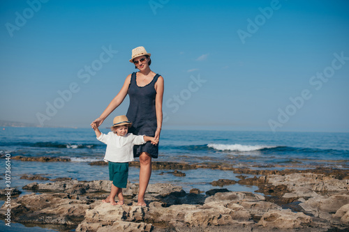 Mom with a little son on a trip near the sea.