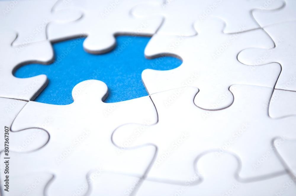 closeup of the last piece of jigsaw puzzle missing on blue background to complete the mission closeup of the last piece of jigsaw puzzle missing on blue background to complete the mission