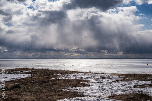 a picture of streams of light coming through the clouds