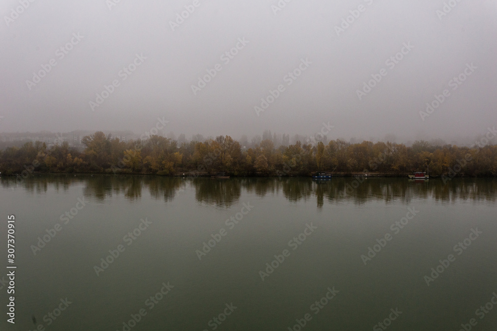 Moody shot of calm river with heavy fog Moody shot of calm river with heavy fog