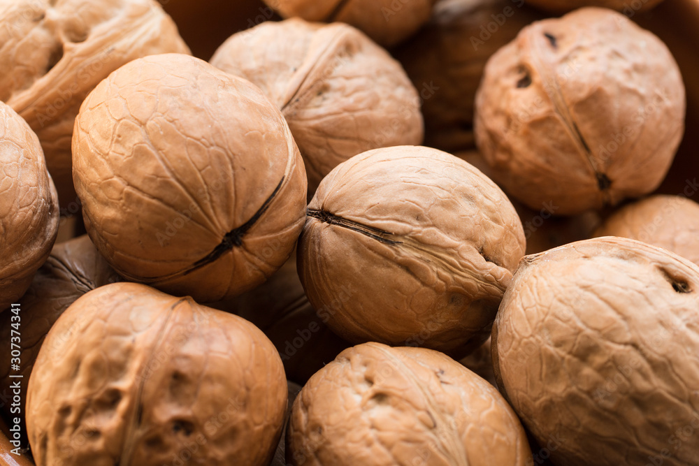 Background of walnuts close up. Close-up of a pile of nuts Background of walnuts close up. Close-up of a pile of nuts