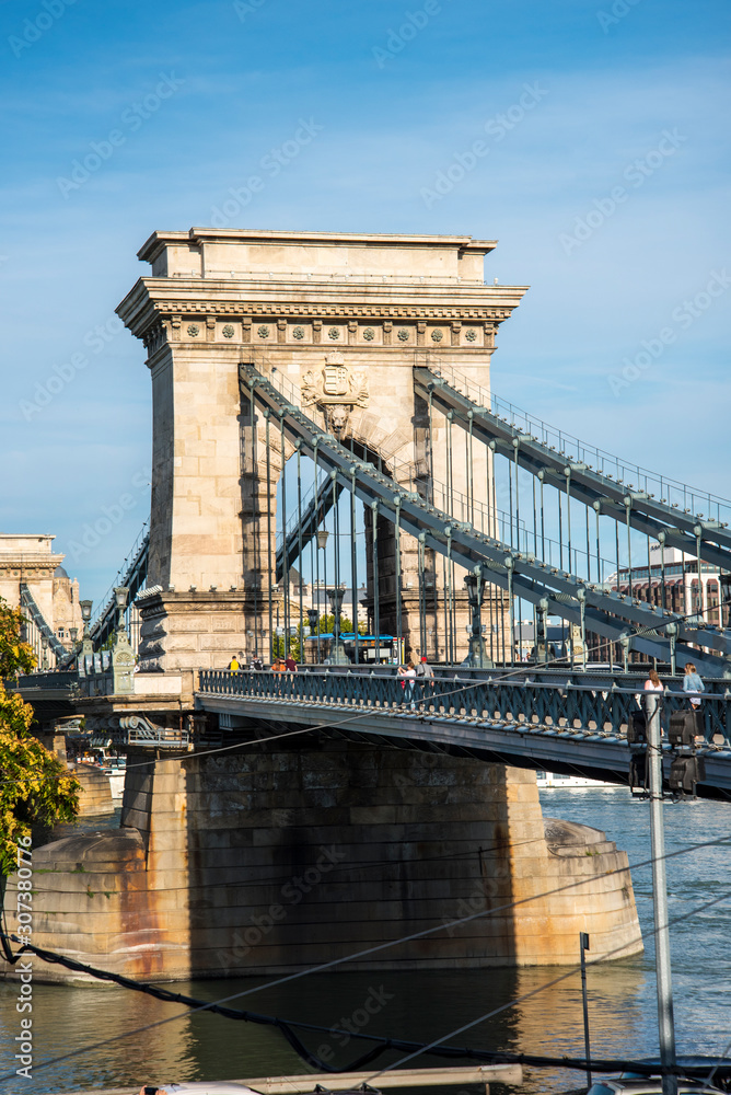 Obraz premium Budapest the Capital city of Hungary is divided by the River Danube.The Chain Bridge opened in 1849 was designed by UK engineer William Tierney Clark