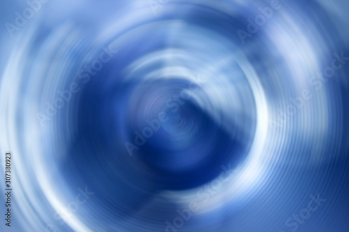 Blurred radial gradient blue white background. Mixed circular texture