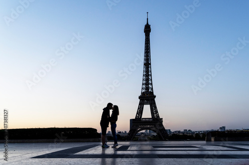 Couple kissing with the Eiffel Tower in Paris in the background © ikuday