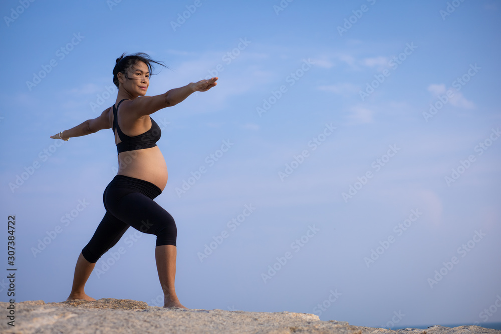 pregnant woman yoga pose on the beach sunset pregnant woman yoga pose on the beach sunset