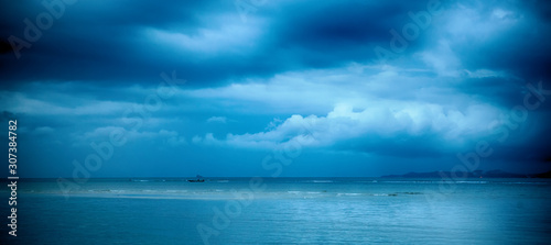 Dramatic stormy dark cloudy sky over sea, natural photo background, panorama baner format