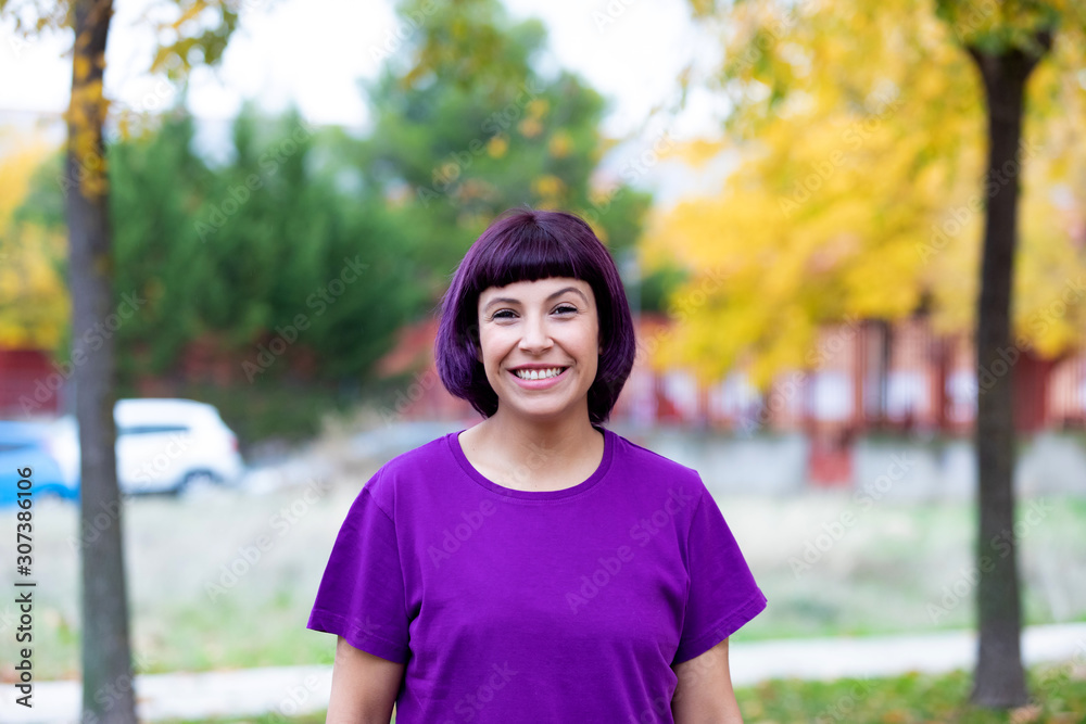 Woman in purple with a yellow tree of background. Woman in purple with a yellow tree of background.