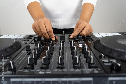 Hands of DJ mixing tracks on professional Dj Mixer © Gayan