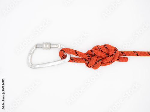 Figure eight knot with carabiner. Silver carabiner with lock and red rope isolated on white.