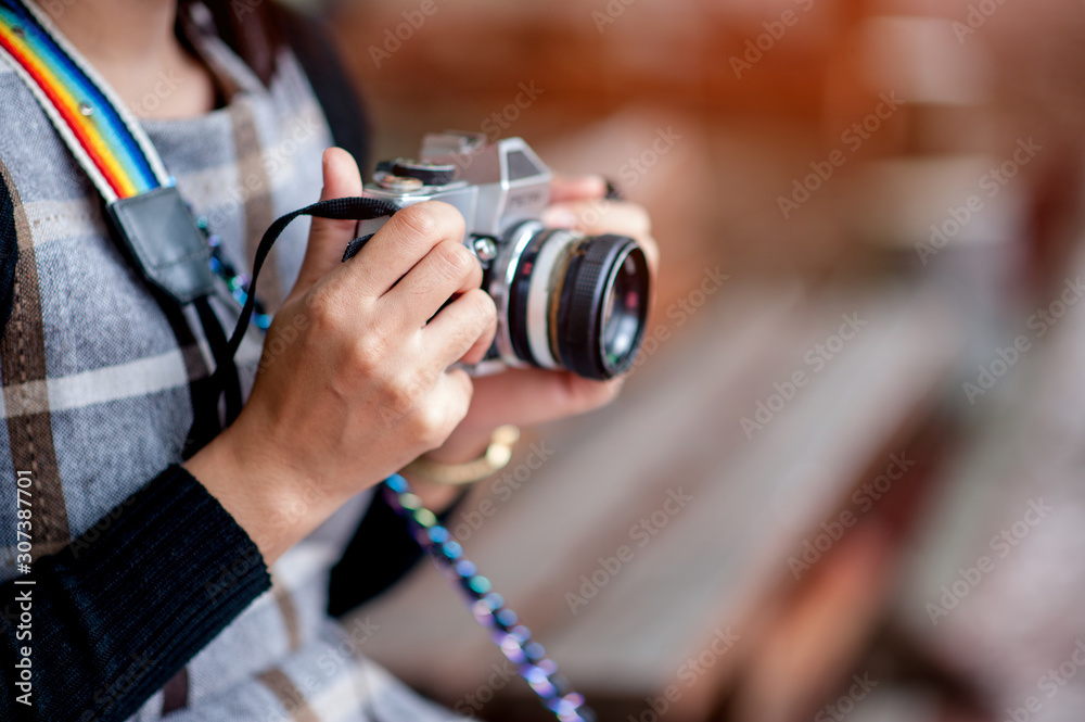 Hand and camera of a travel photographer