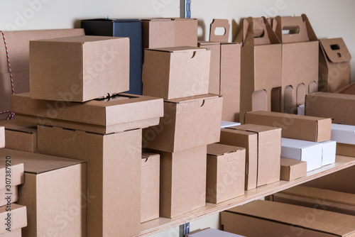 Lot of different cardboard carton boxes in the warehouse photo