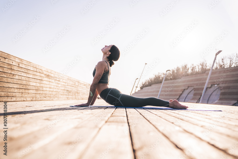 Athletic female relaxing and looking up on exercise mat Athletic female relaxing and looking up on exercise mat