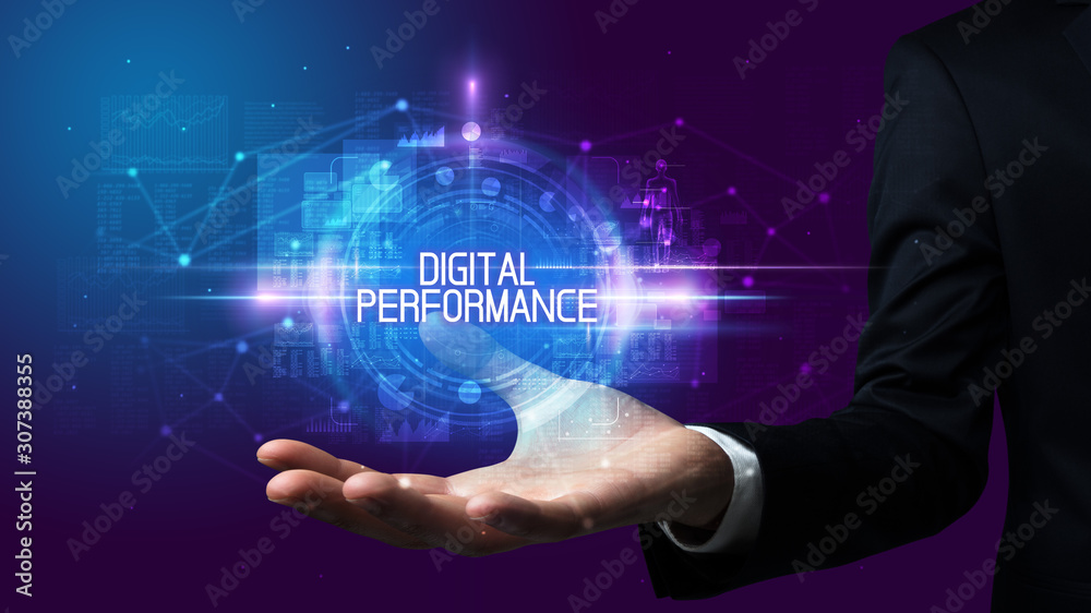 Man hand holding DIGITAL PERFORMANCE inscription, technology concept Man hand holding DIGITAL PERFORMANCE inscription, technology concept