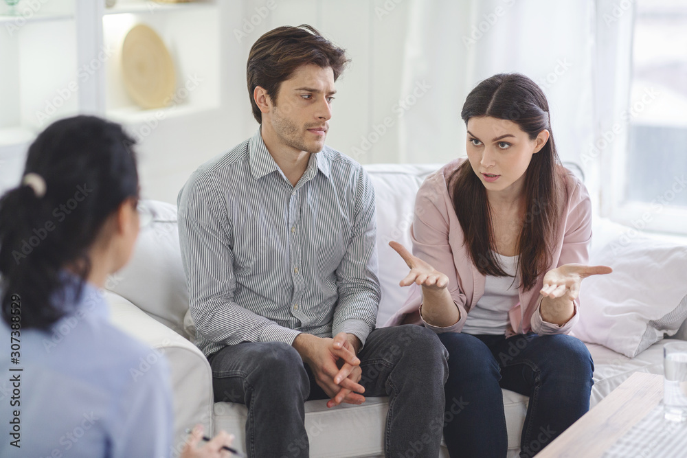 Indignant woman blaming her husband on family therapy Indignant woman blaming her husband on family therapy