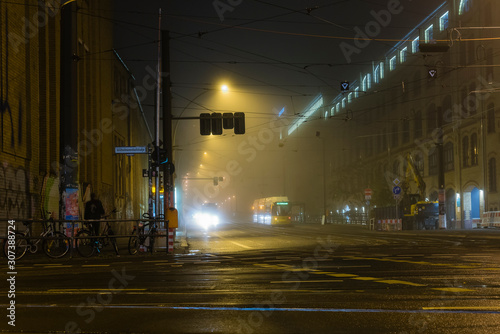 Foggy Cross Road in a city at night, cross roads, wet and foggy cross road, traffic lights, tram station at night, foggy crossroad in Berlin Oberschöneweide